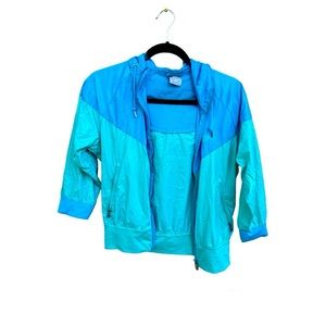 A blue and teal Nike packable rain jacket